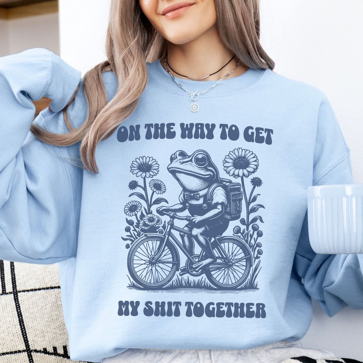 Person wearing a light blue mental health sweatshirt with a graphic design and text.