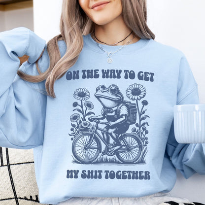 Person wearing a light blue mental health sweatshirt with a graphic design and text.