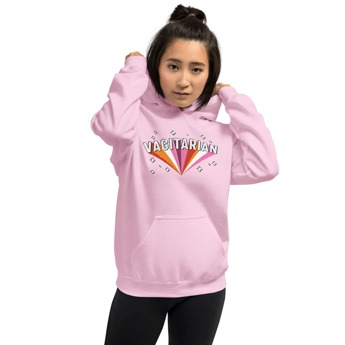 Person wearing a pink lesbian hoodie with 'Vagitarian' text design on a white background