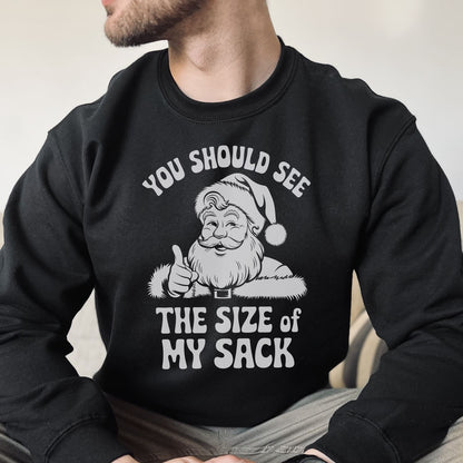 Black sweatshirt with naughty Santa Claus graphic and text on a neutral background