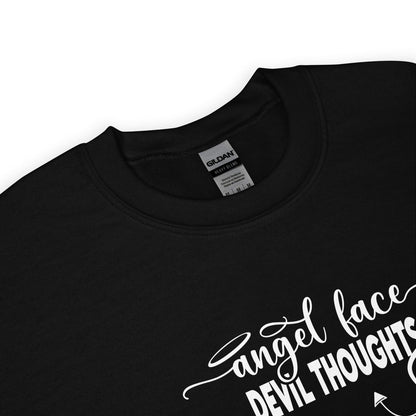 detail of black sweatshirt with white text 'Angel face devil thoughts' on a white background