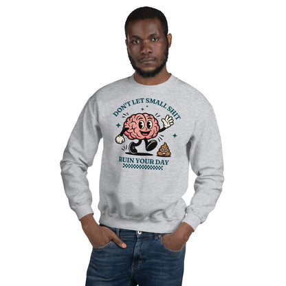 Man wearing a gray positivity sweatshirt with a cartoon brain design and text on a white background