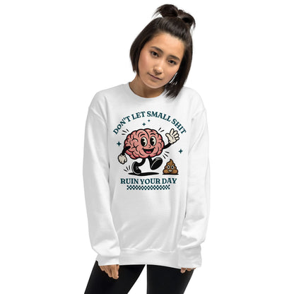Person wearing a white positivity sweatshirt with a graphic design and text on a white background