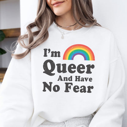 Person wearing a white pride queer sweatshirt with a rainbow and text design.