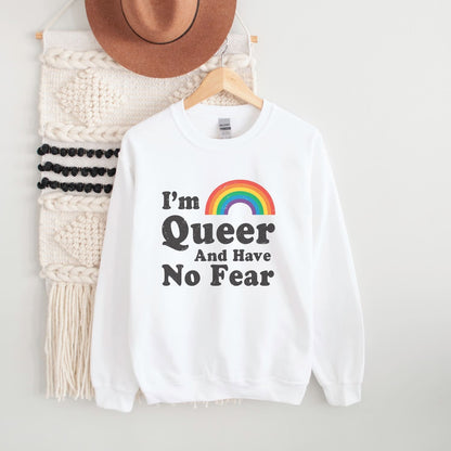 White pride queer sweatshirt with rainbow and text on a hanger against a white background