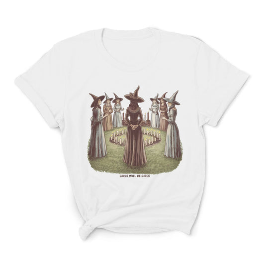 White t-shirt with graphic of witches in hats and dresses on a white background