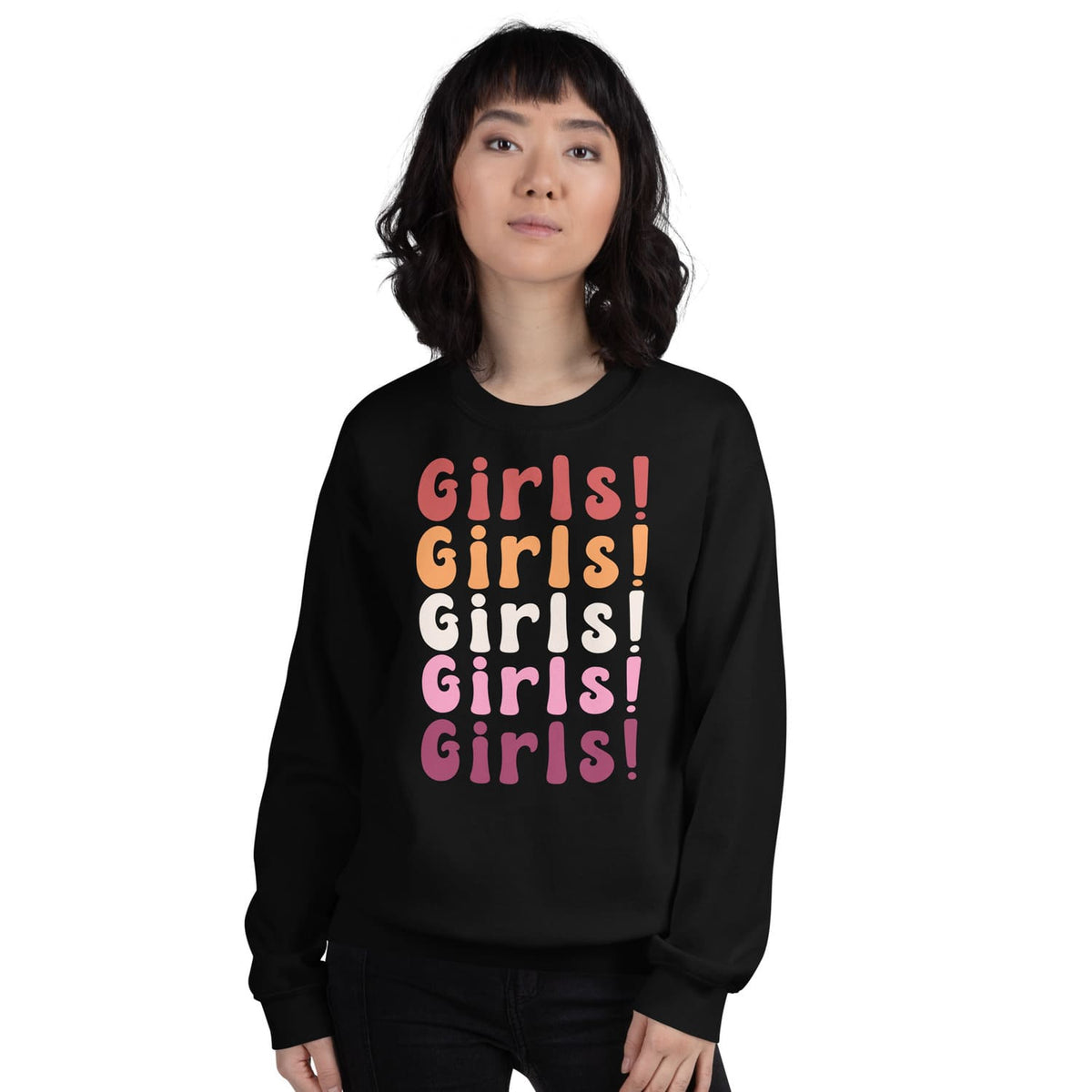 Person wearing a black sweatshirt with 'Girls! Girls! Girls!' text in lesbian sunset flag colors on a white background