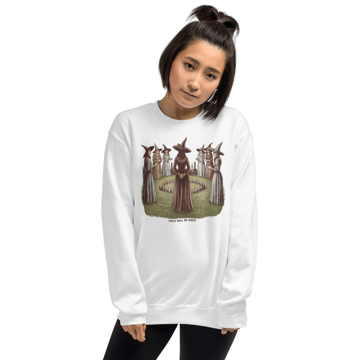 Person wearing a white feminist sweatshirt with a graphic design on a white background