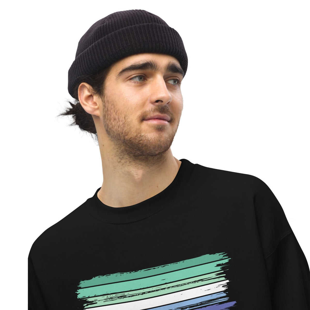 Man wearing a black beanie and black MLM sweatshirt with a colorful design on a white background