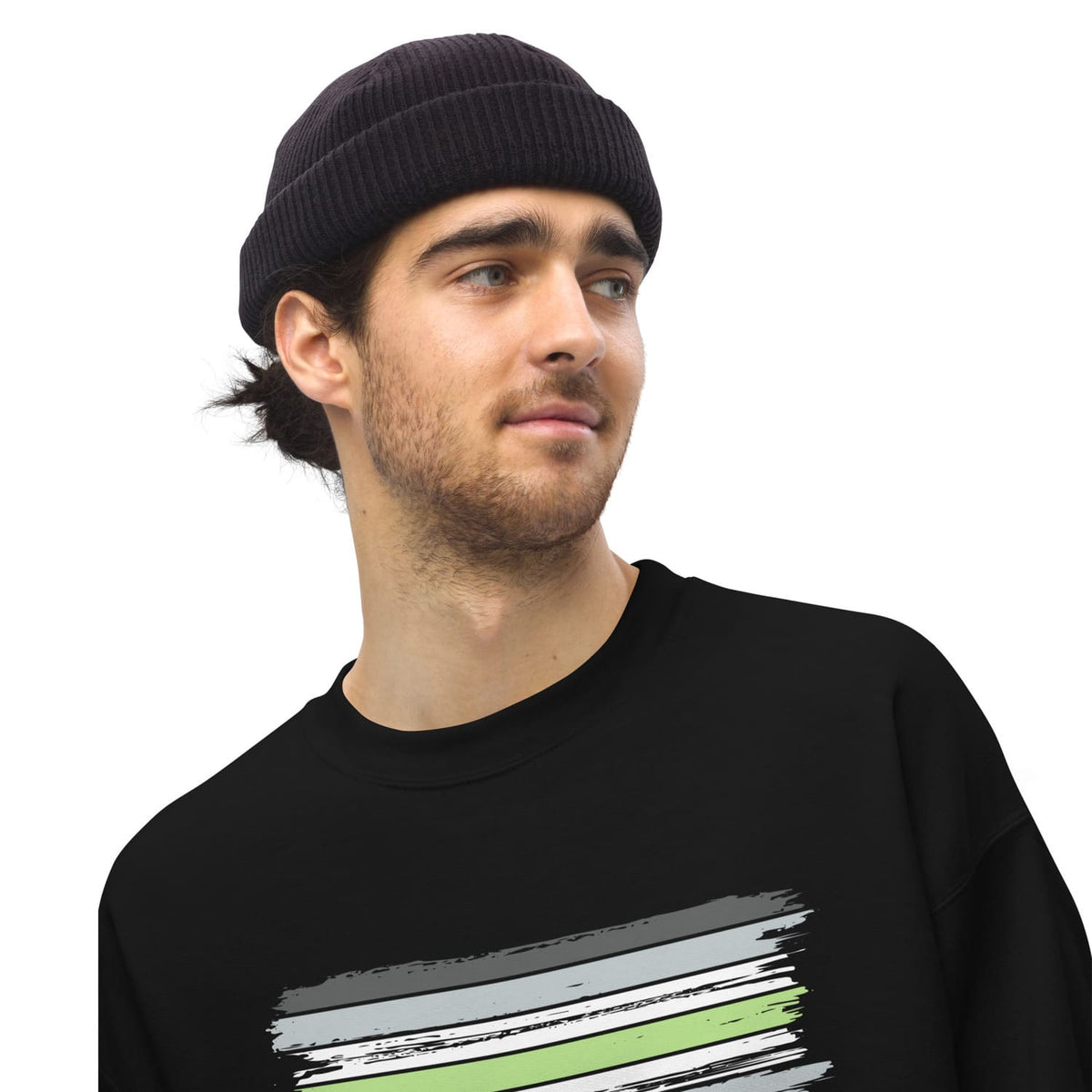 Man wearing a black beanie and black agender sweatshirt with a grunge flag  on a white background