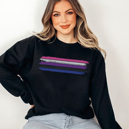 Person wearing a black genderfluid sweatshirt with rainbow stripes on a plain background