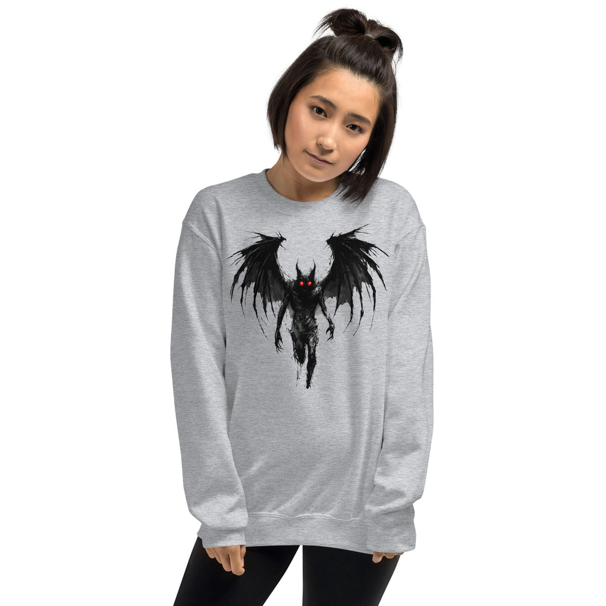 Person wearing a gray sweatshirt with a mothman graphic design on a white background