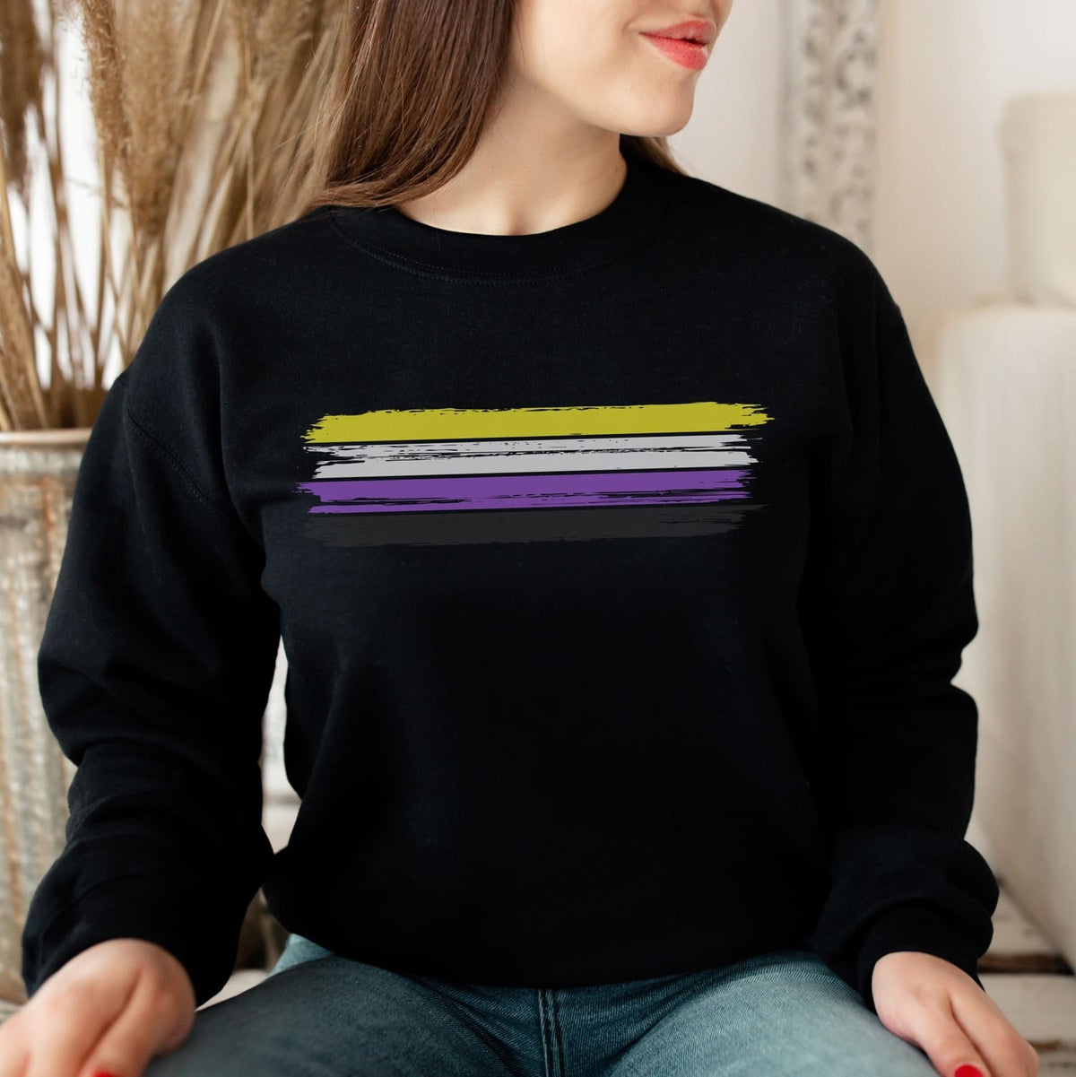 enby Person wearing a black nonbinary sweatshirt with a grunge flag design