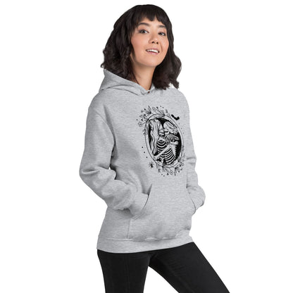Person wearing a gray hoodie with hugging lesbian skeleton couple on a white background