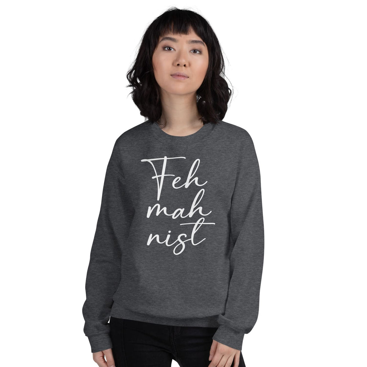 Person wearing a dark gray feminist sweatshirt with 'Feh mah nist' text on a white background
