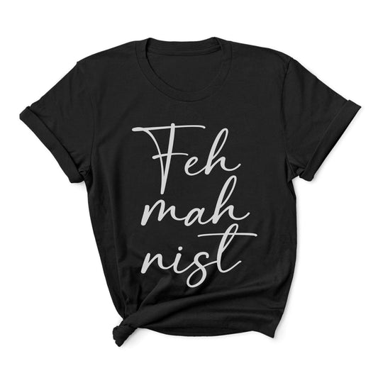 Black feminist t-shirt with white text 'Feh mah nist' on a white background