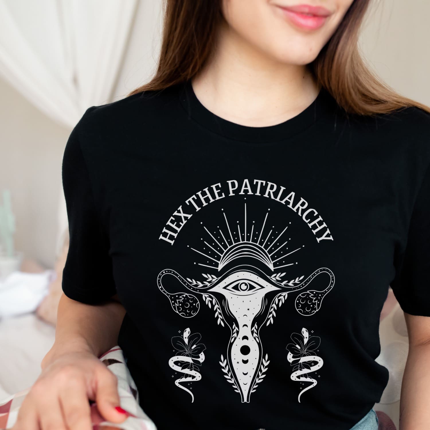 Person wearing a black t-shirt with a graphic design and text hex the patriarchy