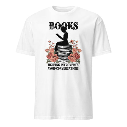 White t-shirt with a graphic design of a silhouette reading a book, surrounded by flowers, with text 'Books helping introverts avoid conversations' on a white background.