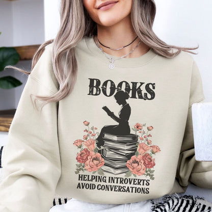 Introvert woman wearing a beige bookish sweatshirt with a graphic design and text.