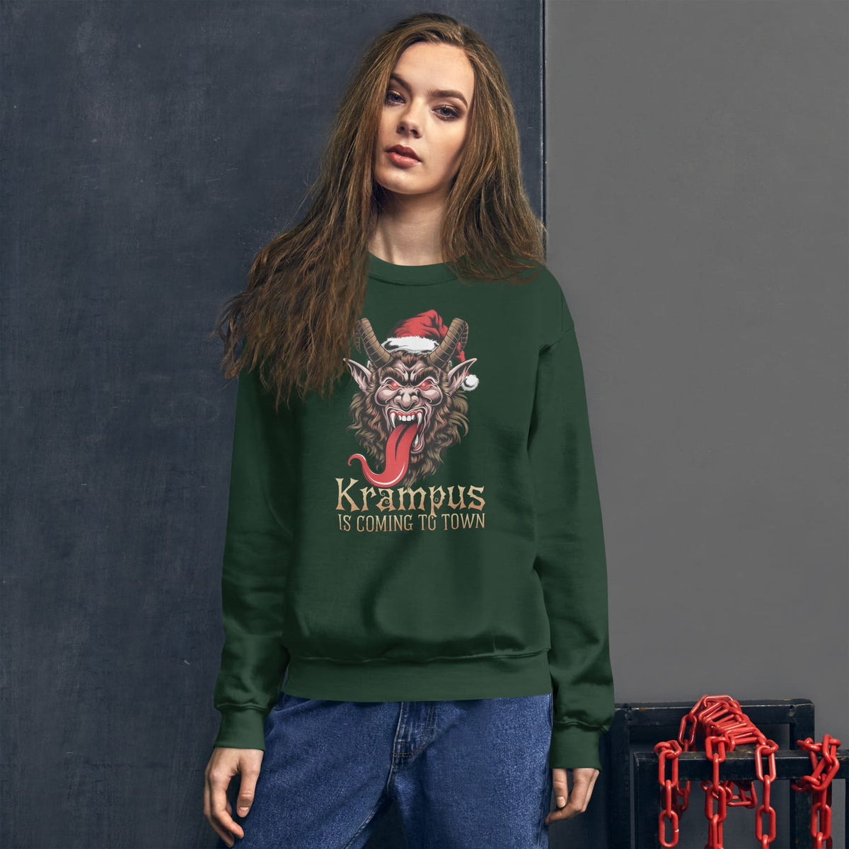 Woman wearing a green sweatshirt with Krampus design against a gray background