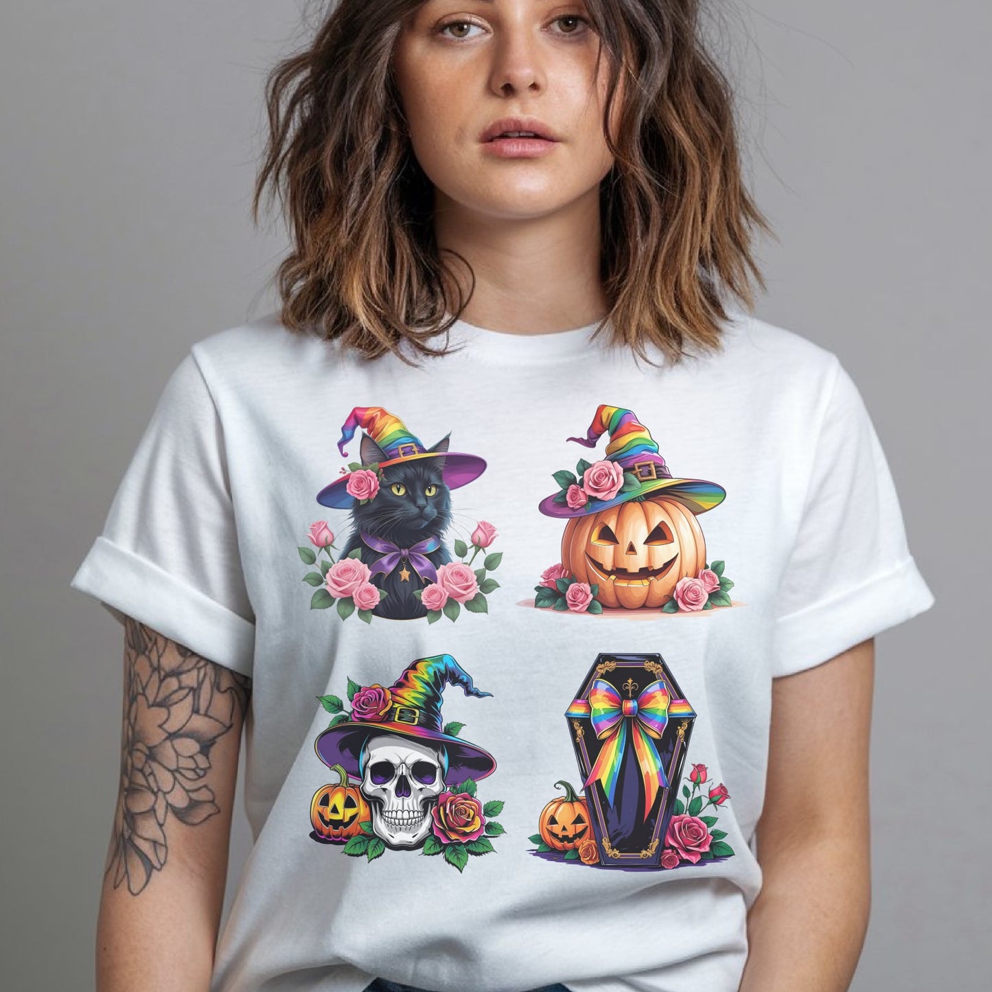 Person wearing a white t-shirt with LGBT pride Halloween-themed designs including a black cat, pumpkin, skull, and coffin.