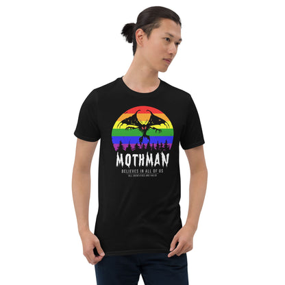 Person wearing a black t-shirt with a colorful graphic and text on a white background: LGBTQ Mothman Shirt, Rainbow Pride Cryptid Folklore T-Shirt, Queer Mythology Legend Cryptozoology Tee, Cryptidcore Weirdcore Gift For LGBT