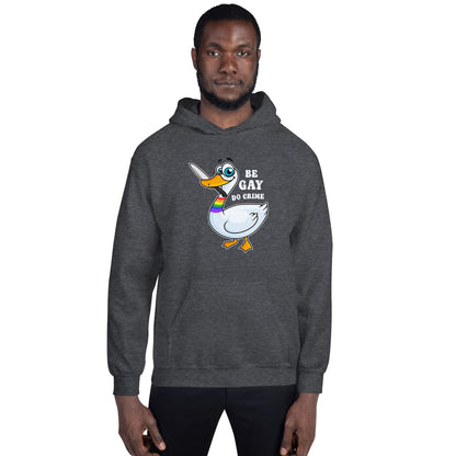 Person wearing a dark gray hoodie with a cartoon duck design and text on a white background, be gay do crime