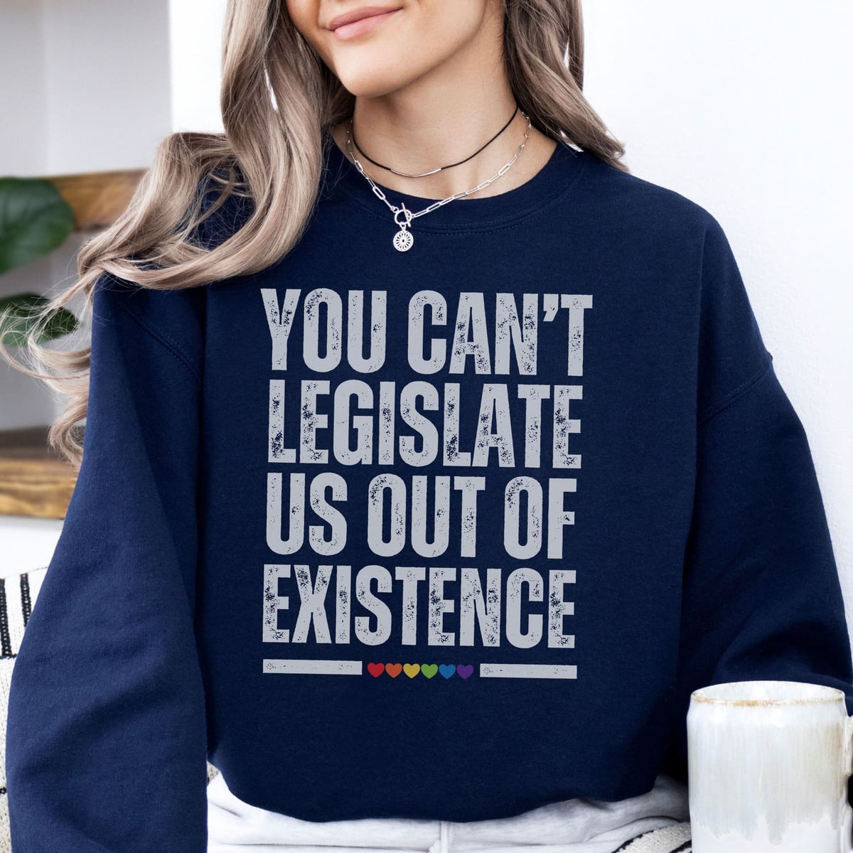 Person wearing a navy blue sweatshirt with an LGBTQ rights quote.