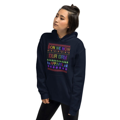 Person wearing a navy christmas hoodie with colorful lgbtq rainbow text and patterns on a white background