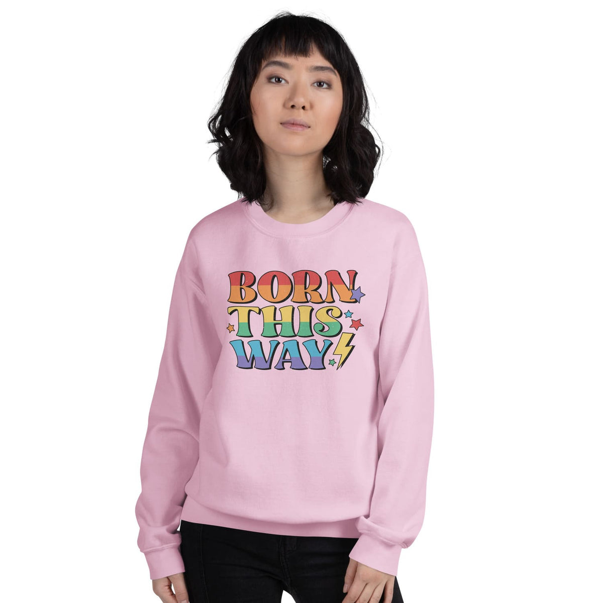 Person wearing a pink lgbtq pride sweatshirt with 'Born This Way' text on a white background