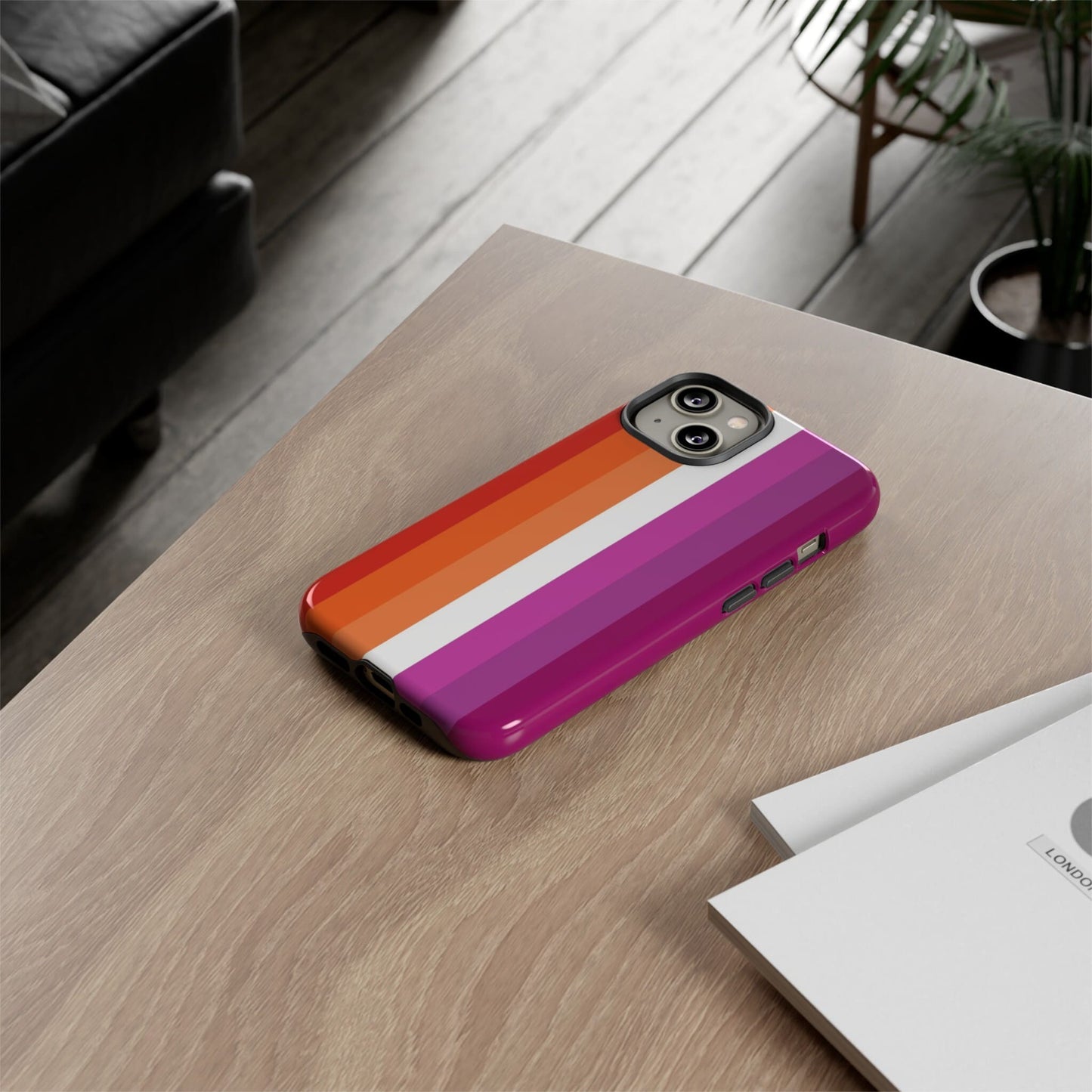 lesbian sunset flag phone case, on table