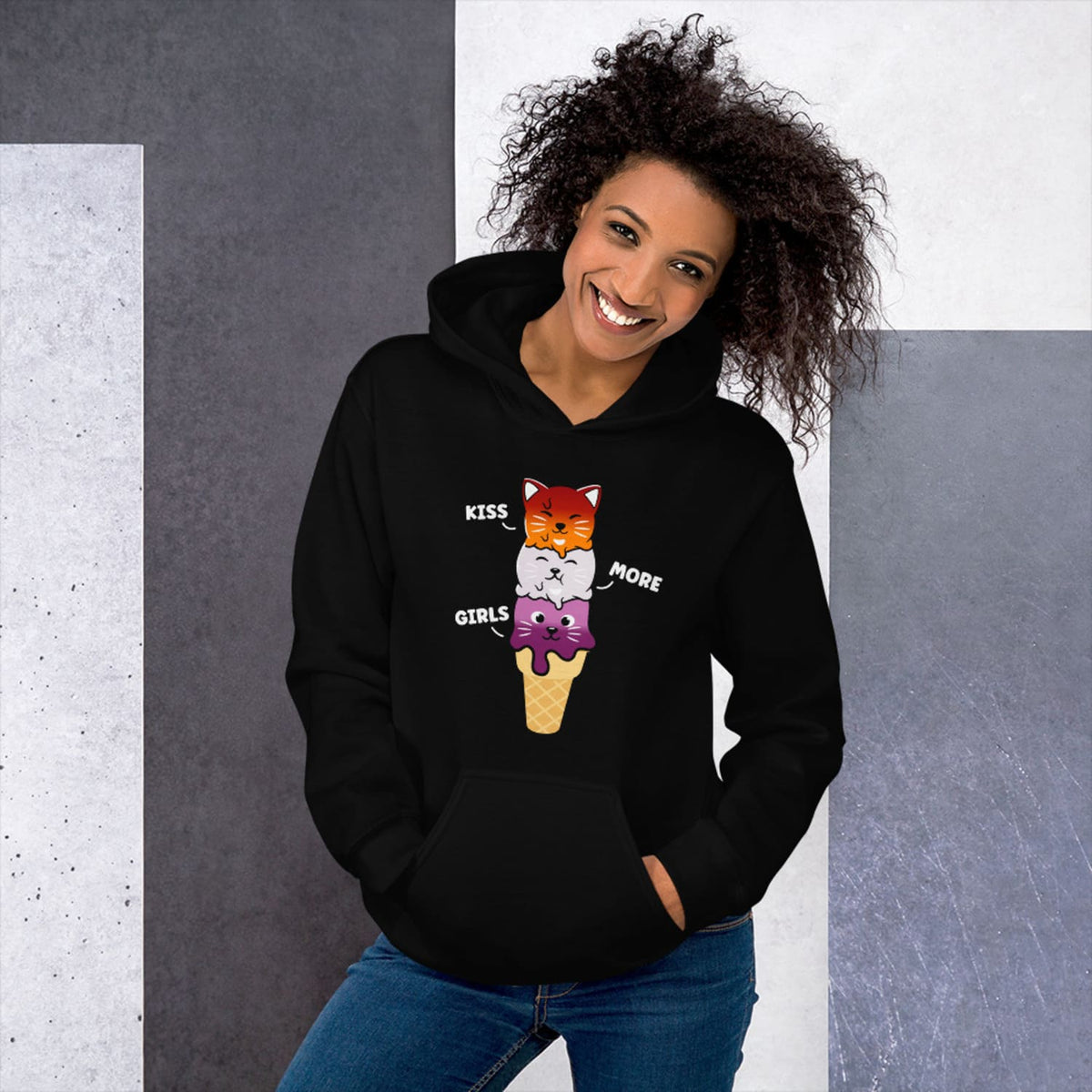 Person wearing a black kawaii lesbian hoodie against a geometric-patterned wall.