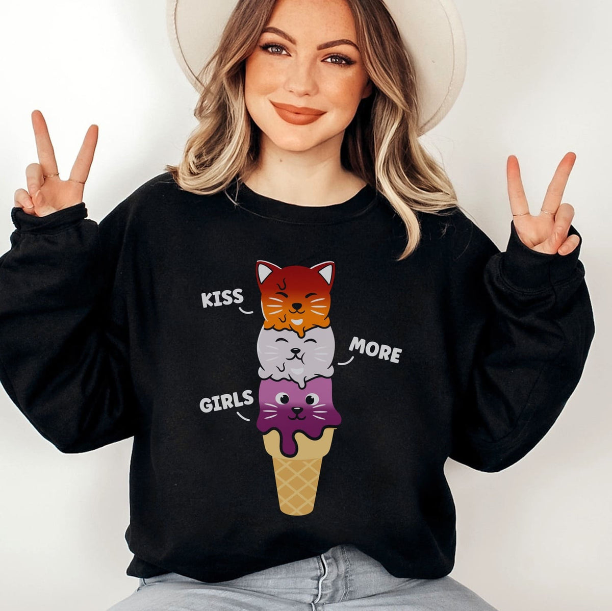 woman wearing a black sweatshirt with lesbian cat-themed design and text