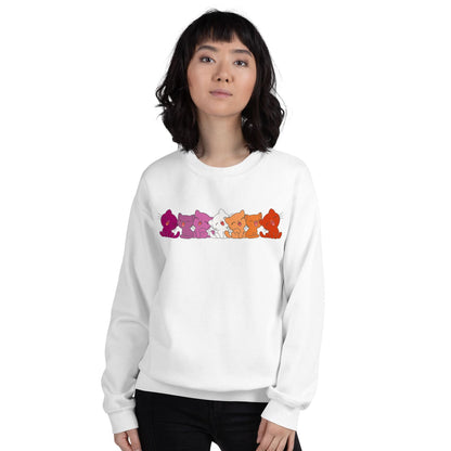 Person wearing a white lesbian sweatshirt with colorful cats illustrations on a white background