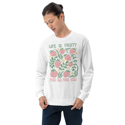Person wearing a white queer sweatshirt with a fruit-themed design and text on a white background