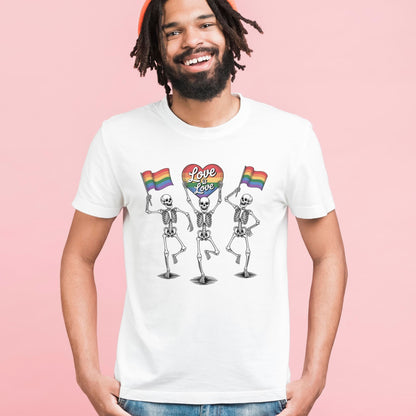 Person wearing a white t-shirt with skeletons holding rainbow flags and 'Love is Love' text on a pink background: Pride Skeleton Shirt, Love Is Love Gay Queer Halloween Tee, LGBTQ Dancing Skeletons T-Shirt, Rainbow LGBT Spooky Season Gift
