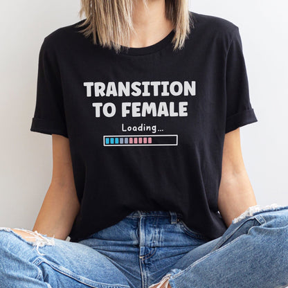 MTF person wearing a black transgender t-shirt with 'Transition to Female Loading' text.