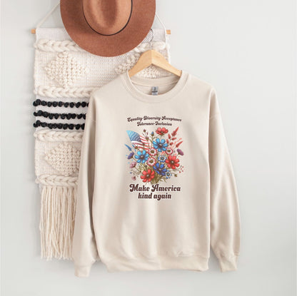 Beige american patriotic sweatshirt with floral design and text, hanging on a wooden hanger with a hat and macramé wall hanging in the background.