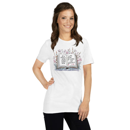 Woman wearing a white t-shirt with a bookish graphic design on a plain background