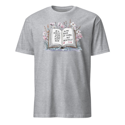 Gray t-shirt with a graphic of a book and flowers on a white background
