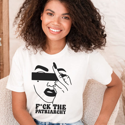 Woman wearing a white feminist t-shirt with a graphic design and text.