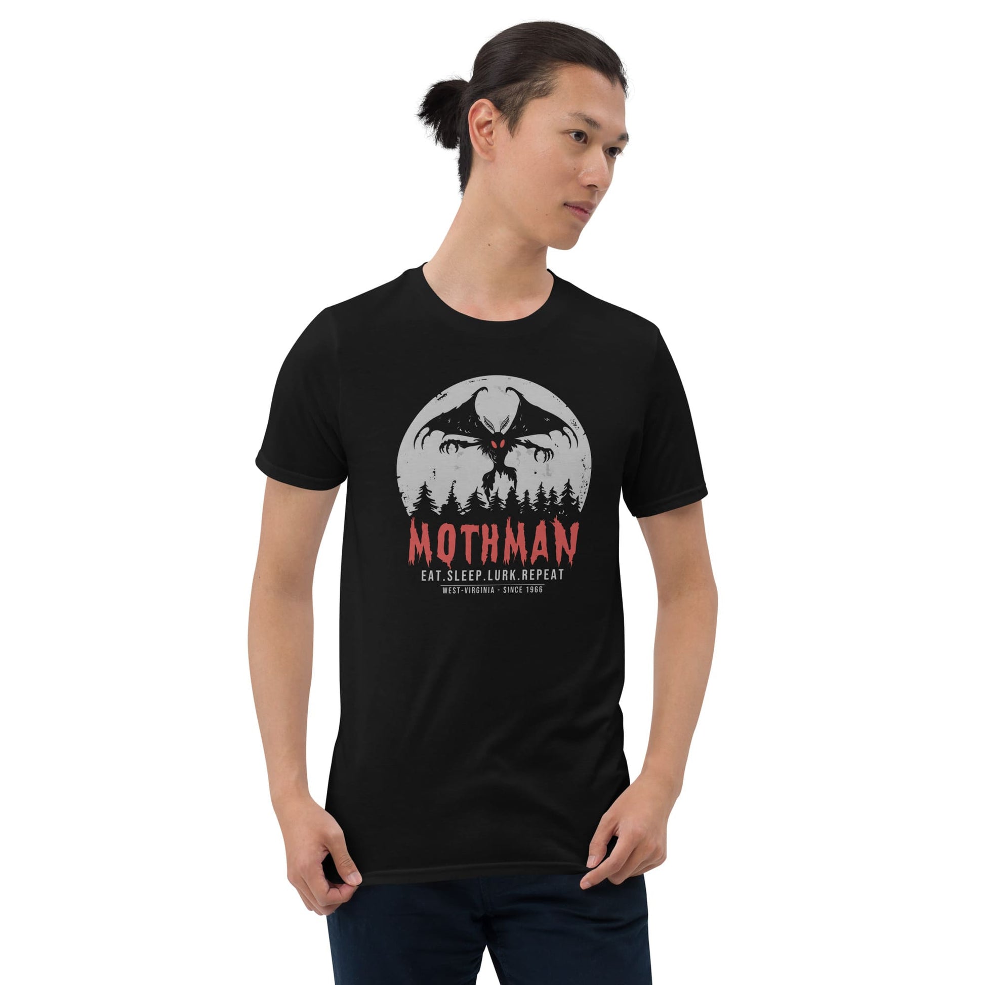 Person wearing a black t-shirt with Mothman graphic design on a white background