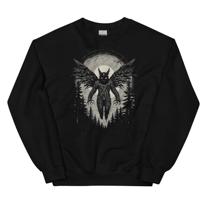 Black sweatshirt with a mothman graphic design in a forest at night.