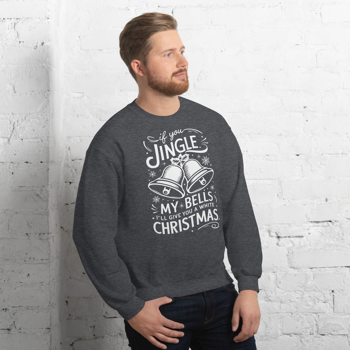 Man wearing a gray funny adult humor sweatshirt with Christmas-themed text against a white brick wall.