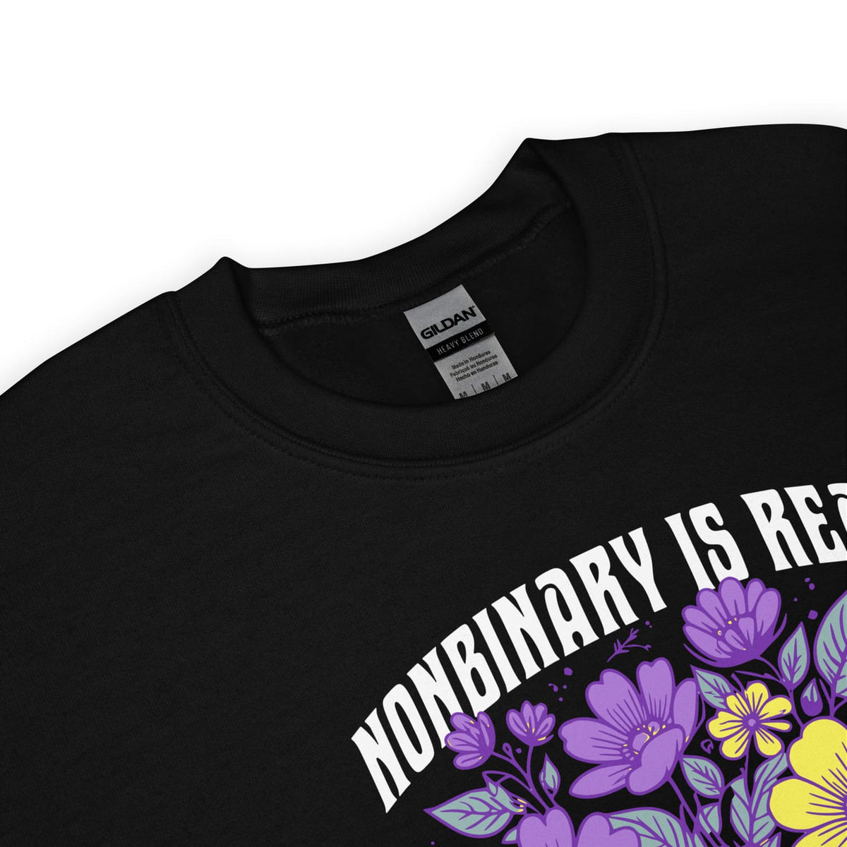 Black sweatshirt with 'NONBINARY IS REAL' text and floral design on a white background