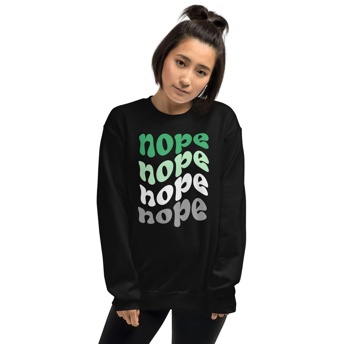 Person wearing a black aromantic sweatshirt with 'nope' text in multiple colors on a white background