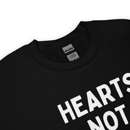 Zoom on pansexual sweatshirt with white text 'HEARTS NOT PARTS' on a white background
