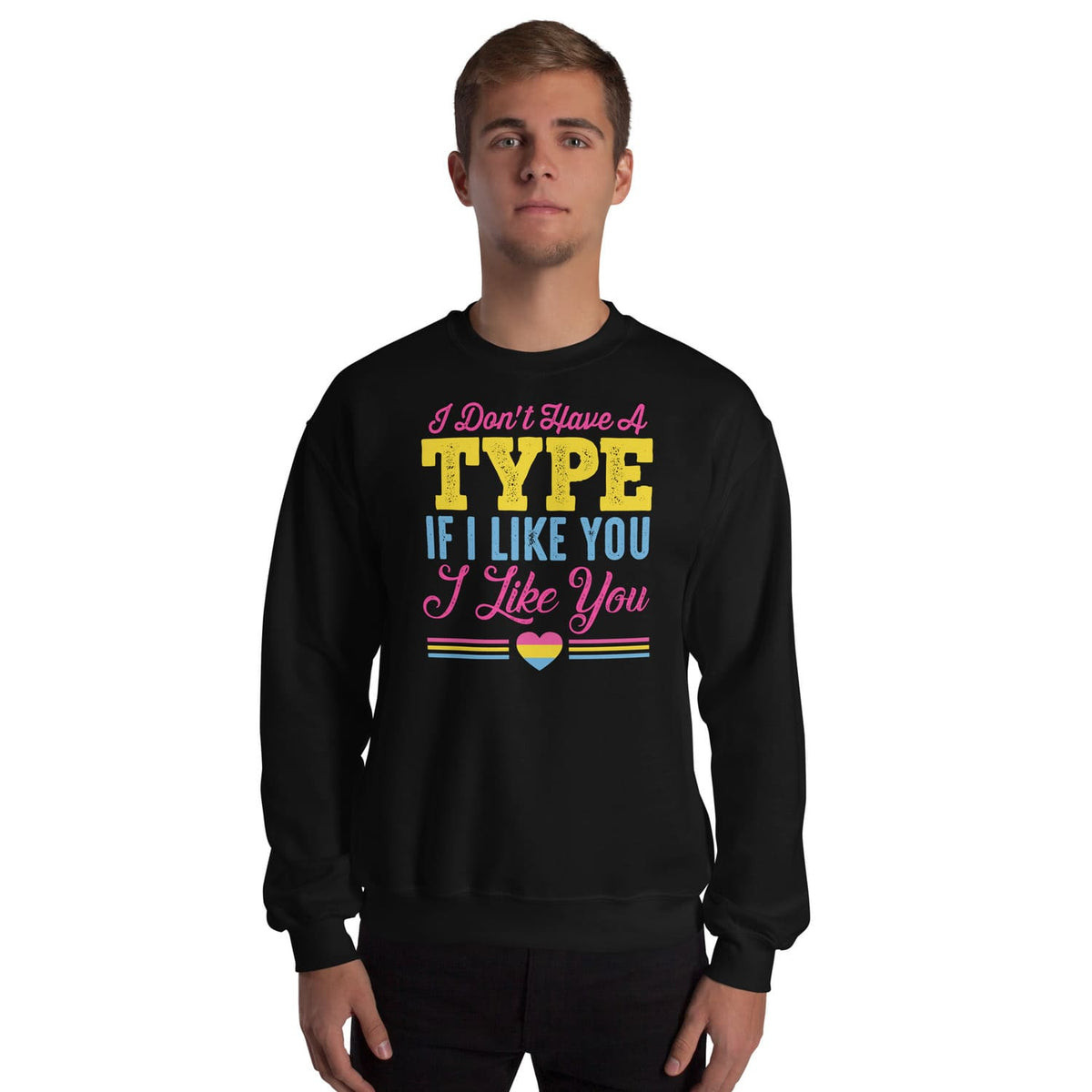 Person wearing a black pansexual sweatshirt with colorful text and a pan pride heart symbol on a white background