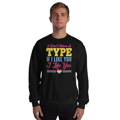 Person wearing a black pansexual sweatshirt with colorful text and a pan pride heart symbol on a white background