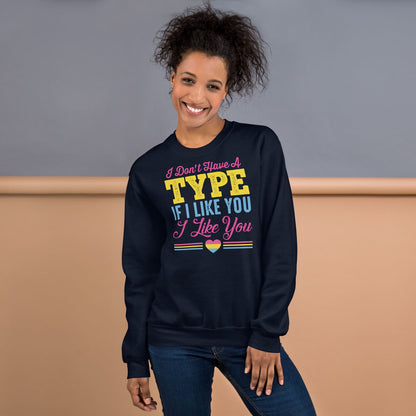 Person wearing a navy pansexual sweatshirt with colorful text and a heart symbol.